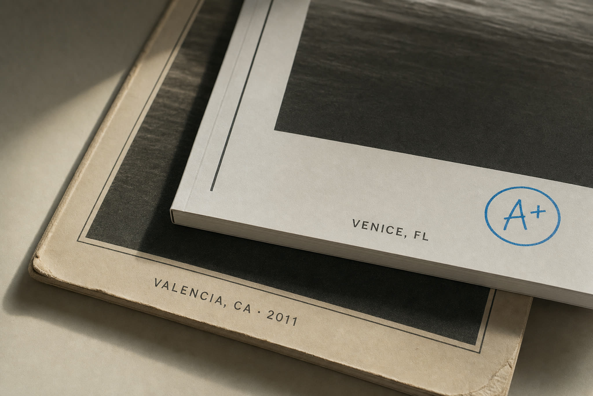Three bound reports on a shelf